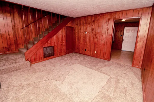 a view of an empty room with wooden walls