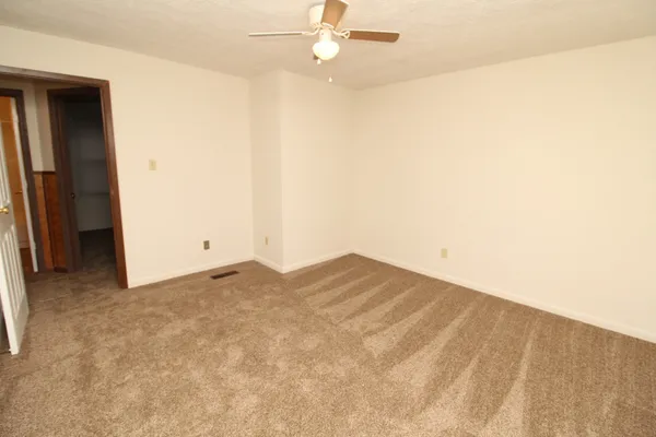 a view of empty room with ceiling fan