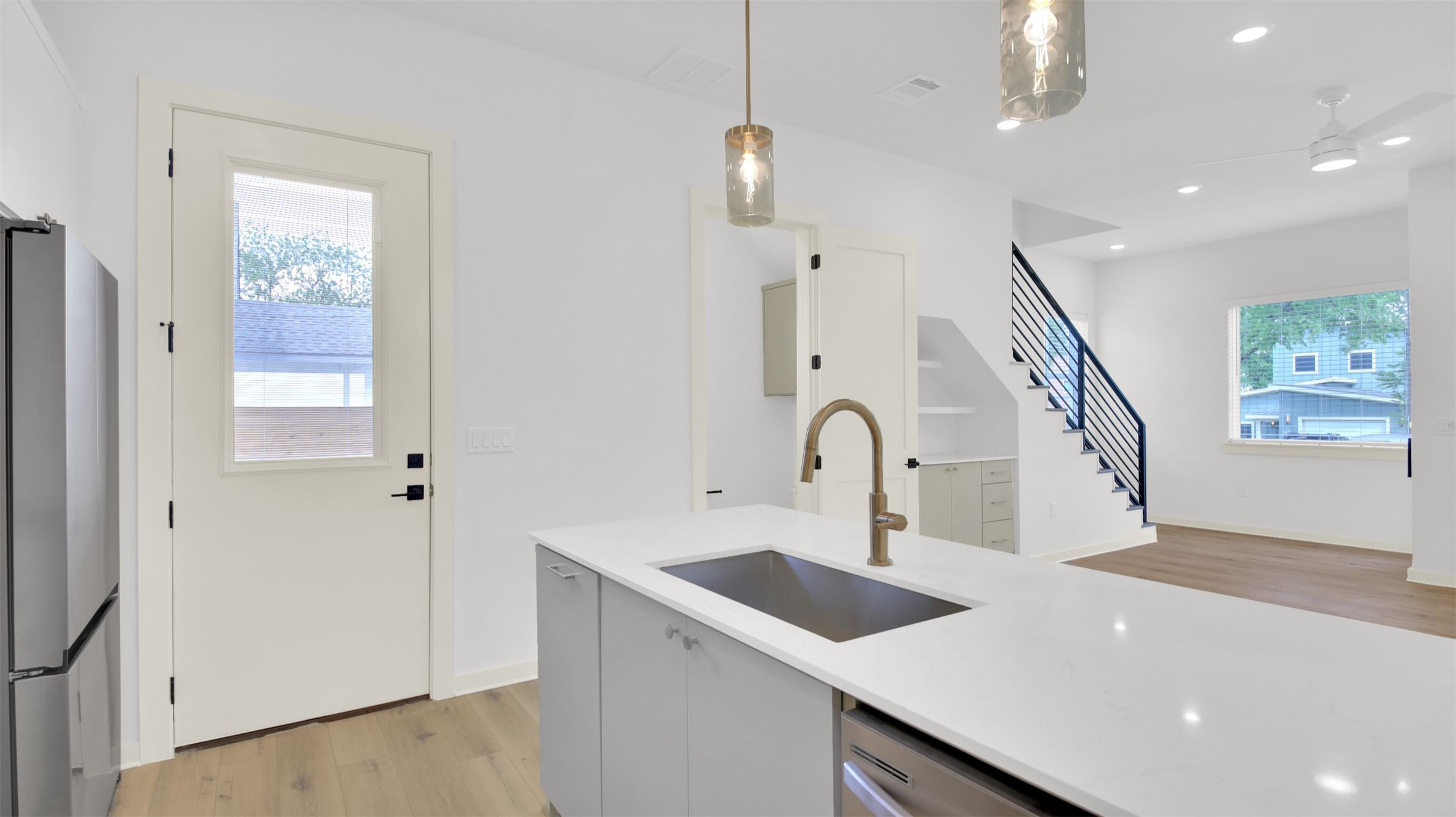 7208 Providence Avenue, Unit 1 Austin, TX 78752 - Photo 11 of 26 The property features a kitchen with a large central island, a built-in sink, and pendant lighting