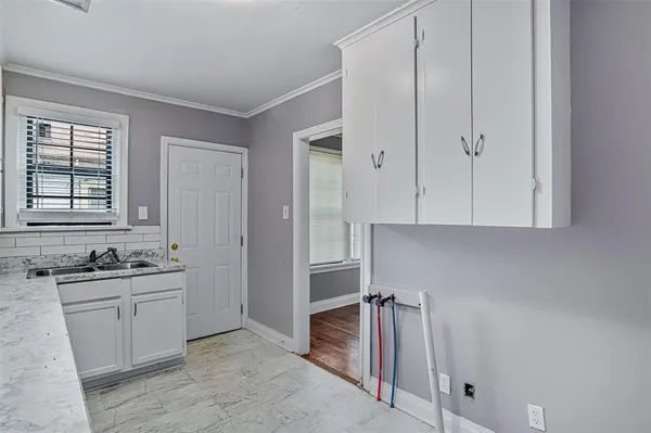 a room that has a sink and cabinets in it
