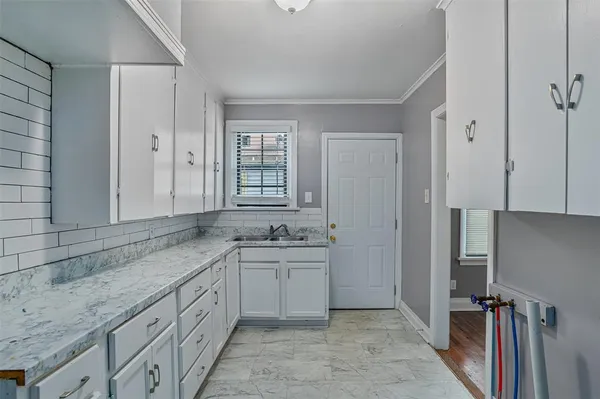 a bathroom with a granite countertop sink a mirror and a bathtub
