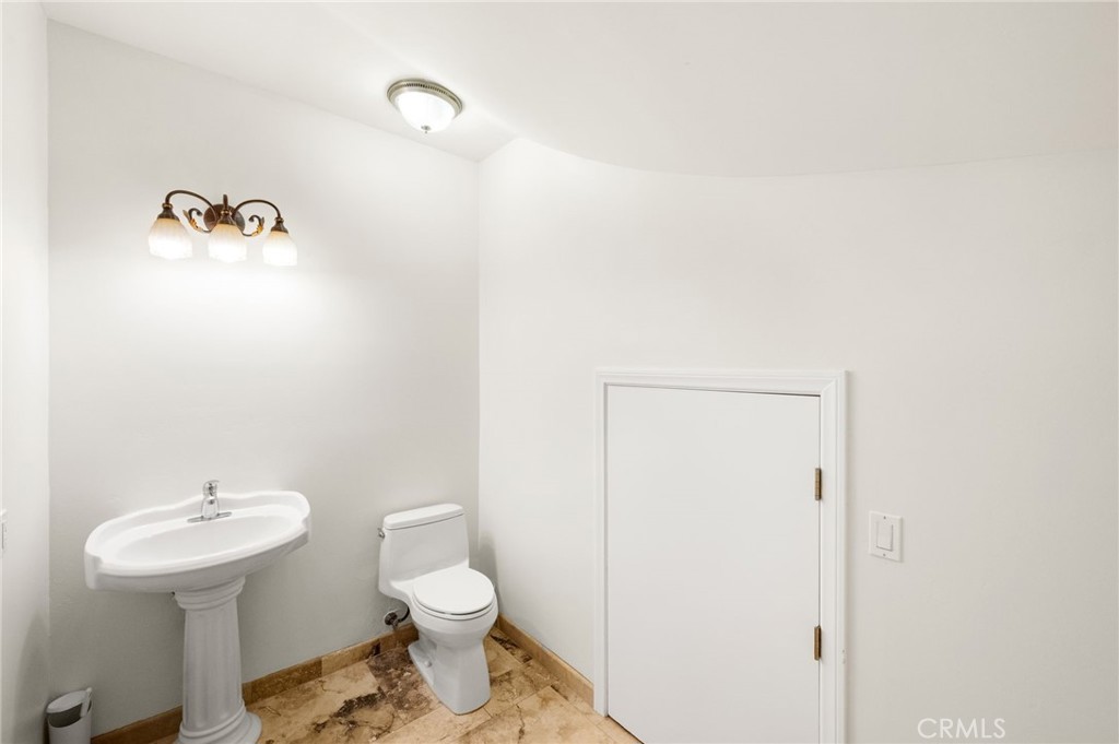 31460 Aquaduct Road Bonsall, CA 92003 - Photo 26 of 57 a bathroom with a sink a toilet and mirror