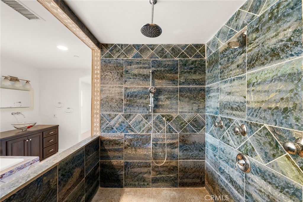 31460 Aquaduct Road Bonsall, CA 92003 - Photo 29 of 57 a bathroom with a double vanity sink and a mirror