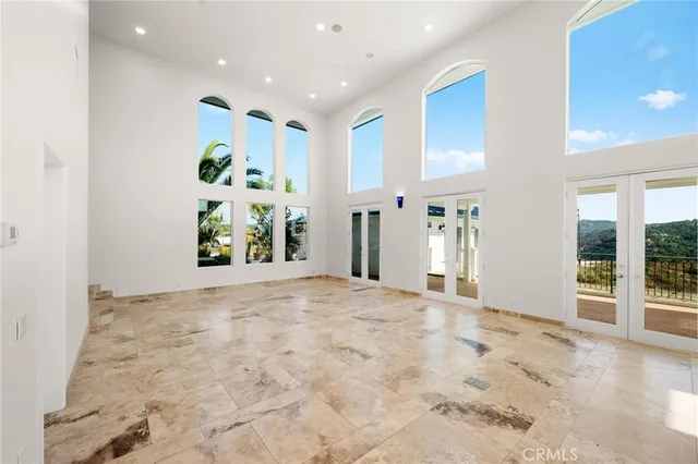 a view of a livingroom with wooden floor and a fireplace