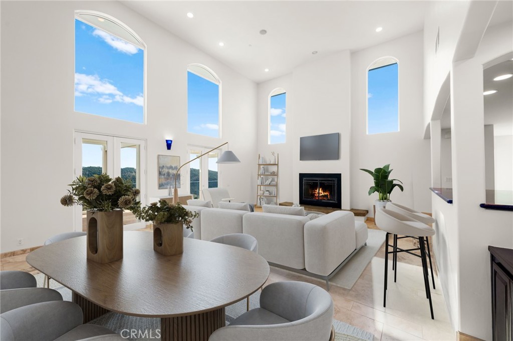 31460 Aquaduct Road Bonsall, CA 92003 - Photo 8 of 57 a dining room with furniture a potted plant and a fireplace