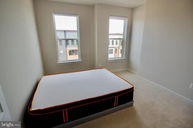 a bed sitting in a bedroom next to a window