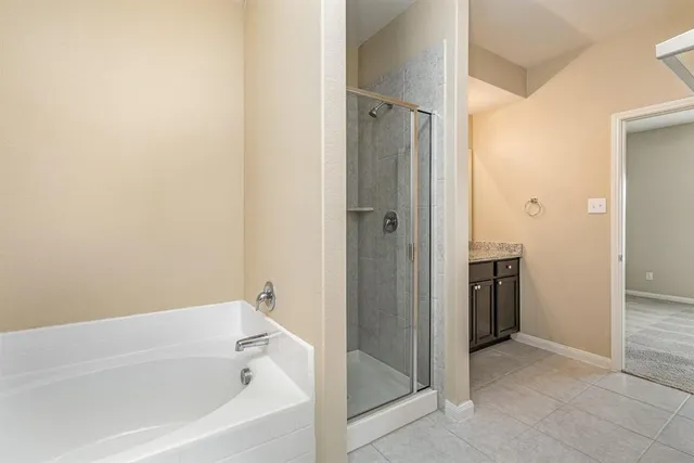 a bathroom with a bathtub and shower