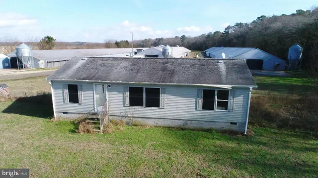 a aerial view of a house with table and chairs
