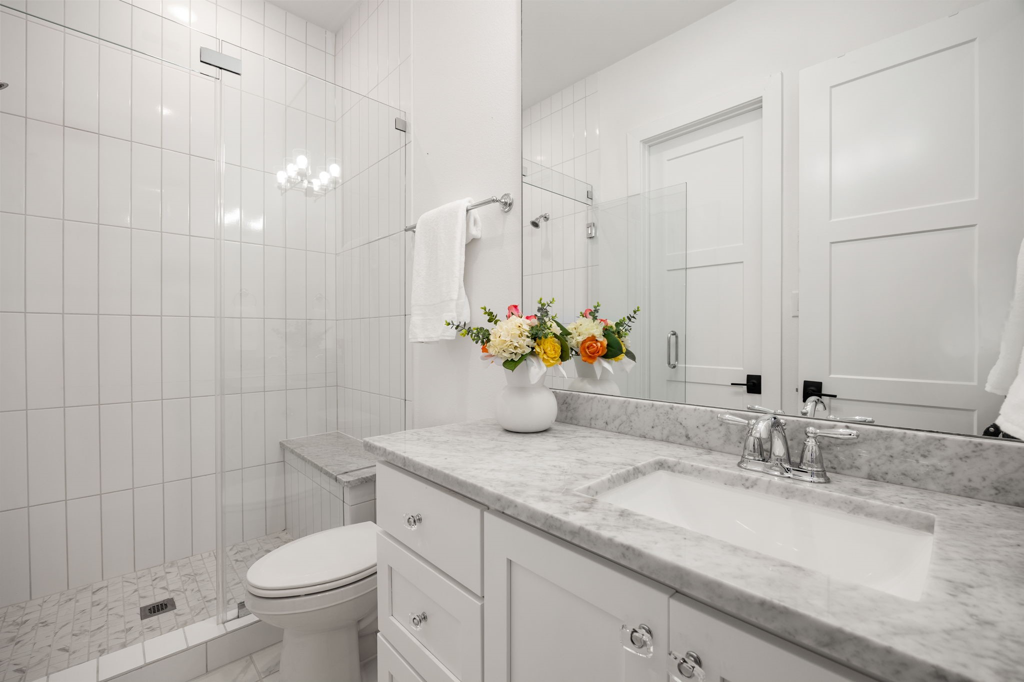 27903 Indigo Ridge Drive Fulshear, TX 77441 - Photo 32 of 50 Elegant en-suite bath featuring marble-look countertops, a frameless glass shower, and timeless designer finishes.