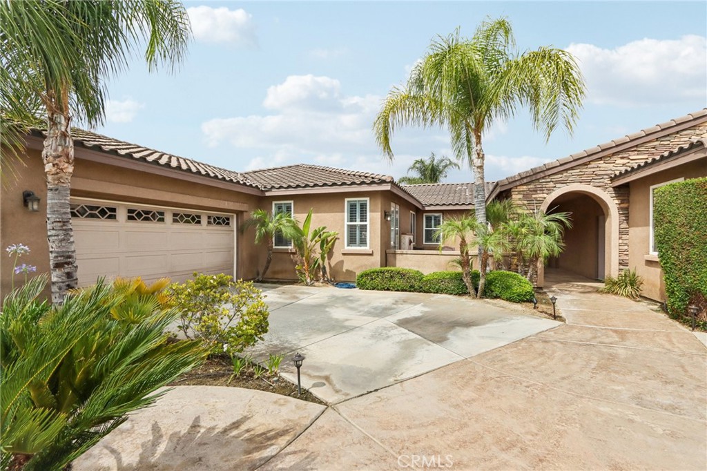 16577 Edge Gate Drive Riverside, CA 92504 - Photo 1 of 1 a front view of a house with a garden