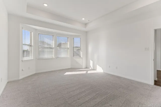 a view of a room with wooden floor and windows
