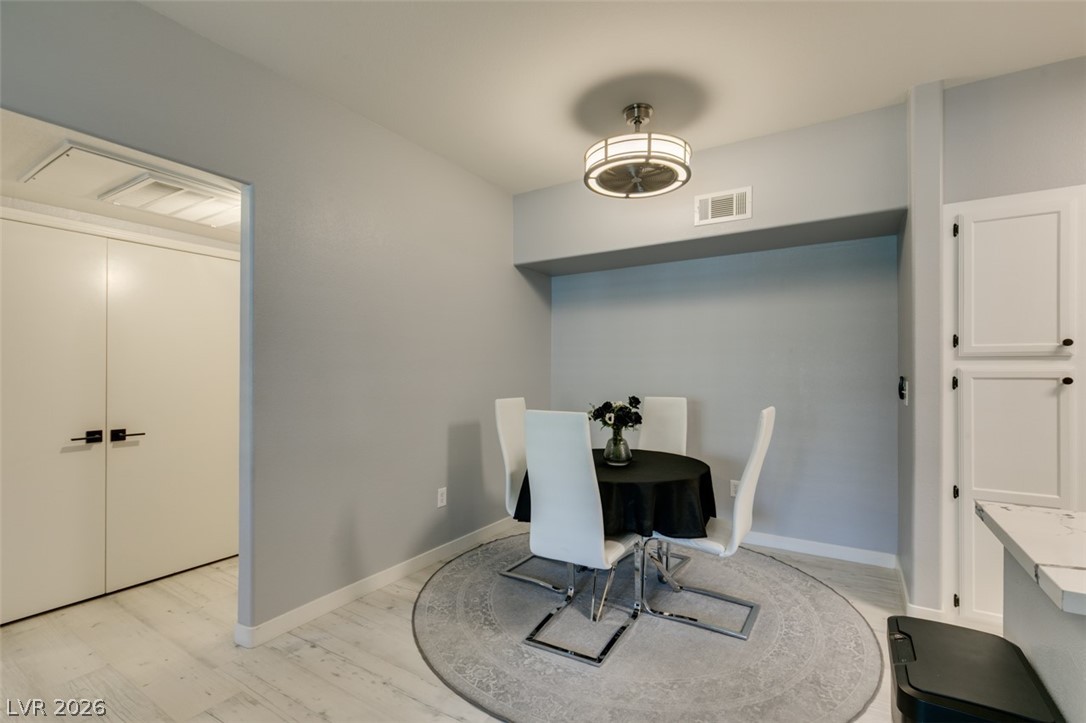7255 West Sunset Road, Unit 1103 Las Vegas, NV 89113 - Photo 19 of 35 A compact dining area with a circular rug offers an intimate setting for meals.