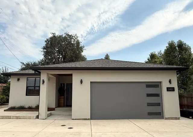 a front view of a house with a garden