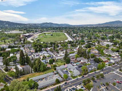 an aerial view of residential houses with outdoor space and river view