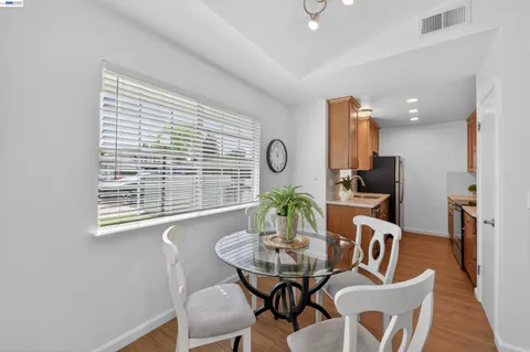 a view of a dining room with furniture window and wooden floor