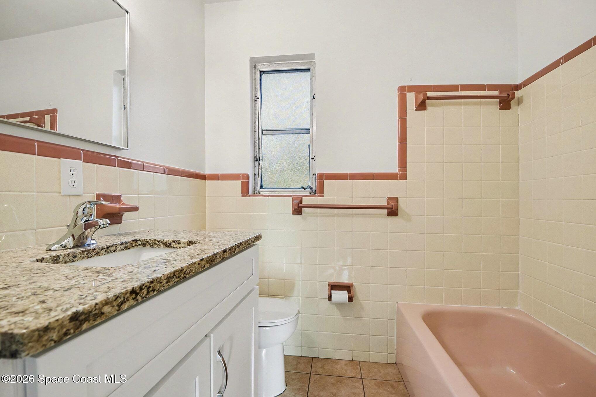 3105 Highway 1, Unit 1 Mims, FL 32754 - Photo 6 of 7 a bathroom with a granite countertop tub sink and mirror