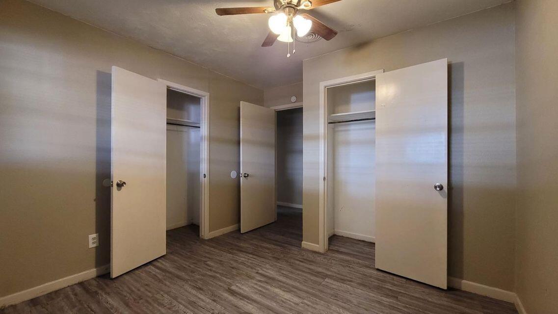 4429 31st Street Lubbock, TX 79410 - Photo 11 of 12 an empty room with wooden floor closet and chandelier fan