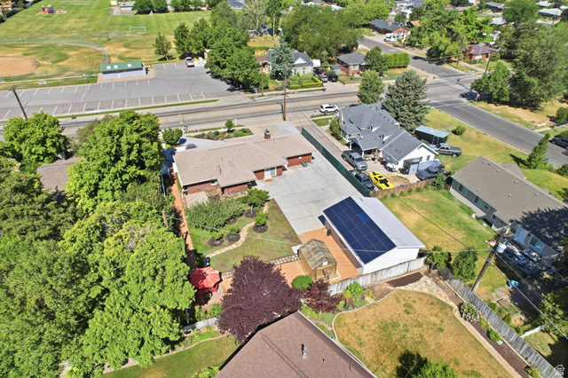 1180 North 400 East Bountiful, UT 84010 - Photo 44 of 50 Aerial perspective showcasing a single-story residence with a paved driveway and an adjacent structure featuring solar panels