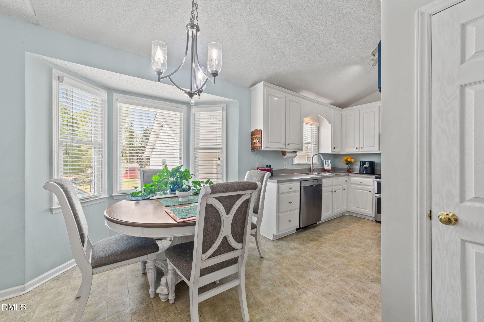 709 Slippery Bank Court Benson, NC 27504 - Photo 23 of 43 a kitchen with a dining table chairs and refrigerator