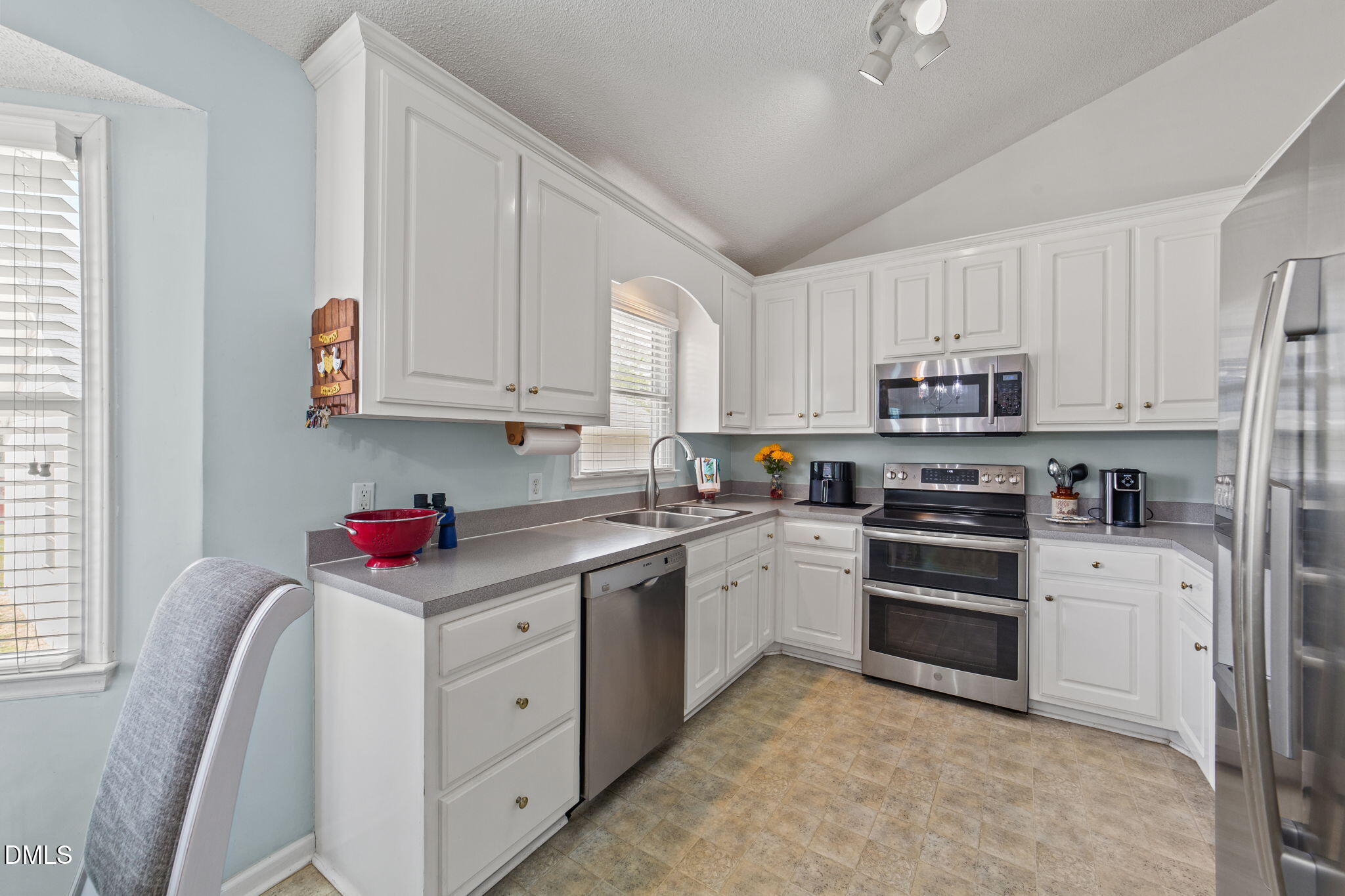 709 Slippery Bank Court Benson, NC 27504 - Photo 24 of 43 a kitchen with stainless steel appliances granite countertop a stove sink and cabinets