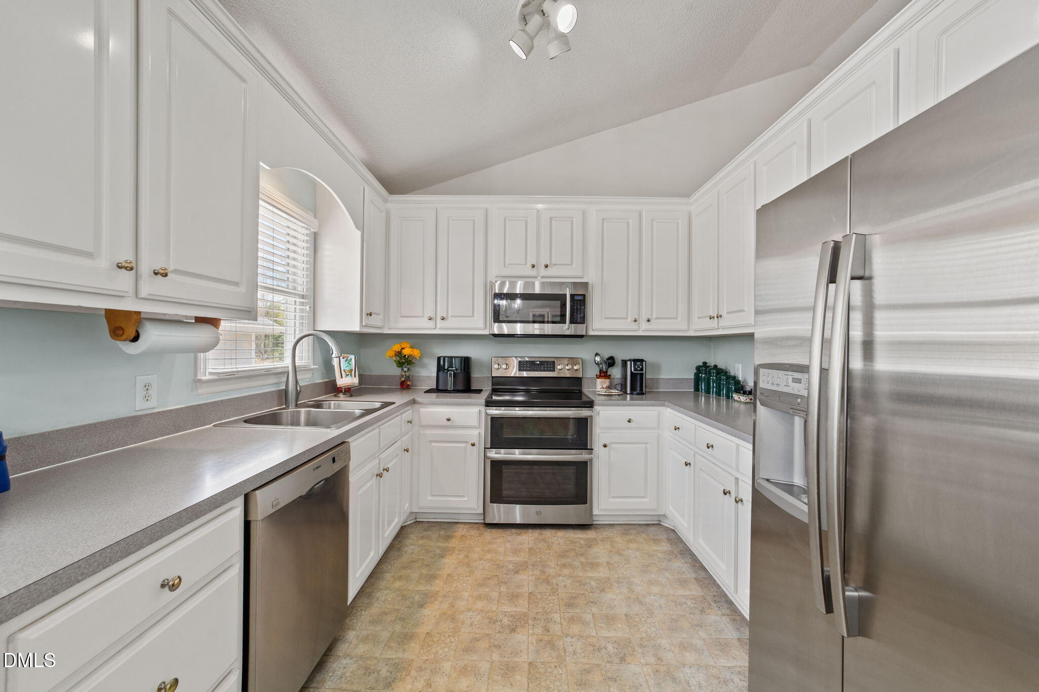 709 Slippery Bank Court Benson, NC 27504 - Photo 25 of 43 a kitchen with granite countertop white cabinets and stainless steel appliances