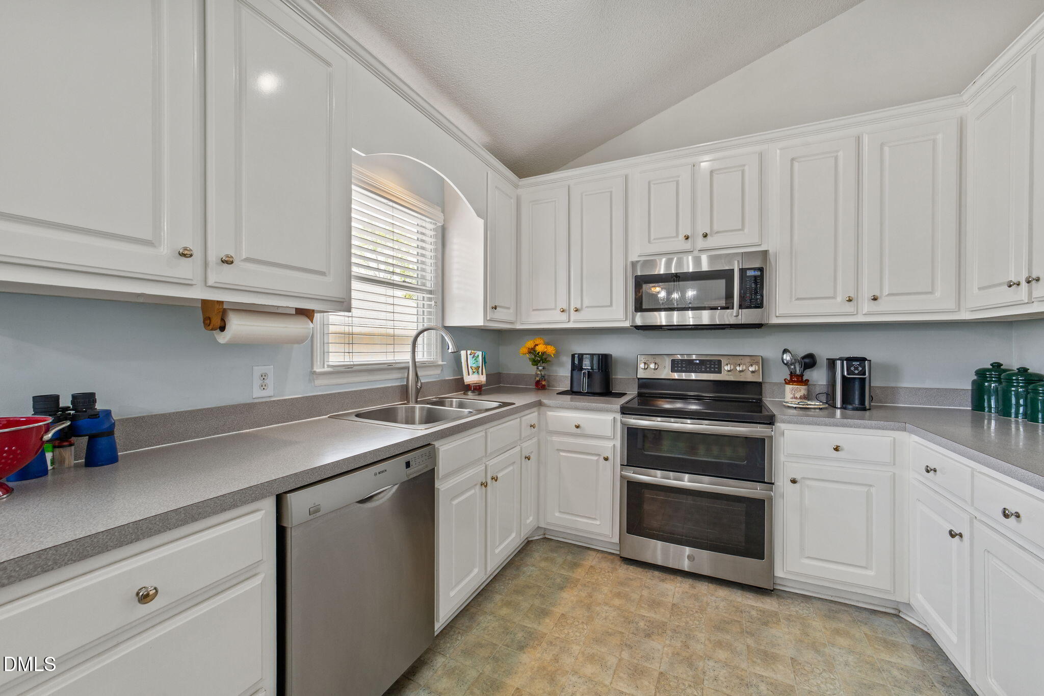 709 Slippery Bank Court Benson, NC 27504 - Photo 26 of 43 a kitchen with cabinets appliances a sink and a window
