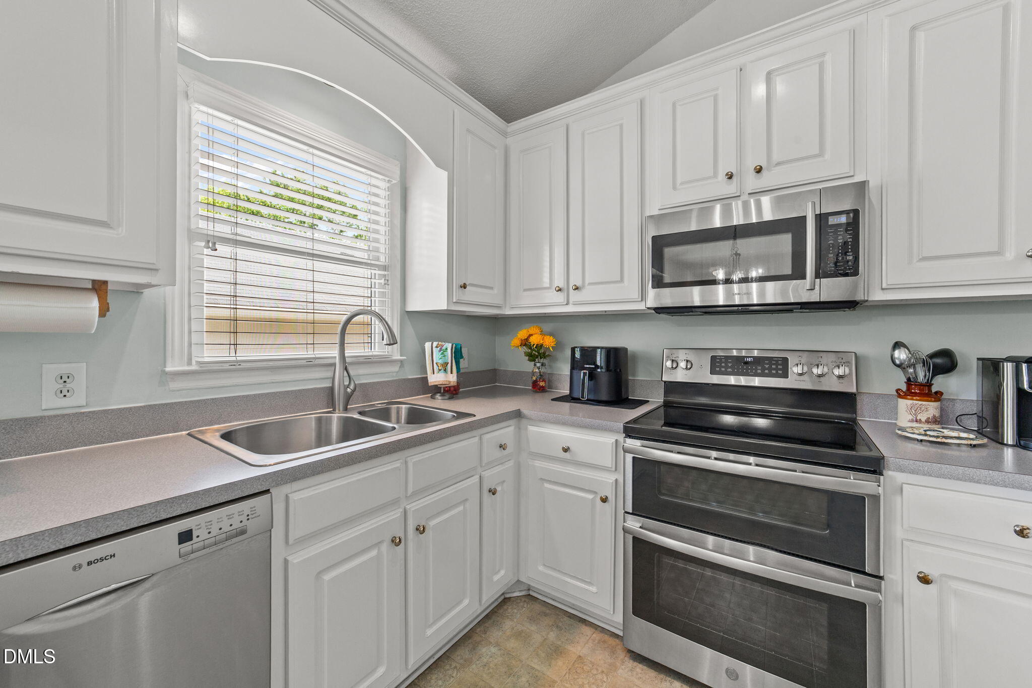 709 Slippery Bank Court Benson, NC 27504 - Photo 27 of 43 a kitchen with cabinets appliances a sink and a window