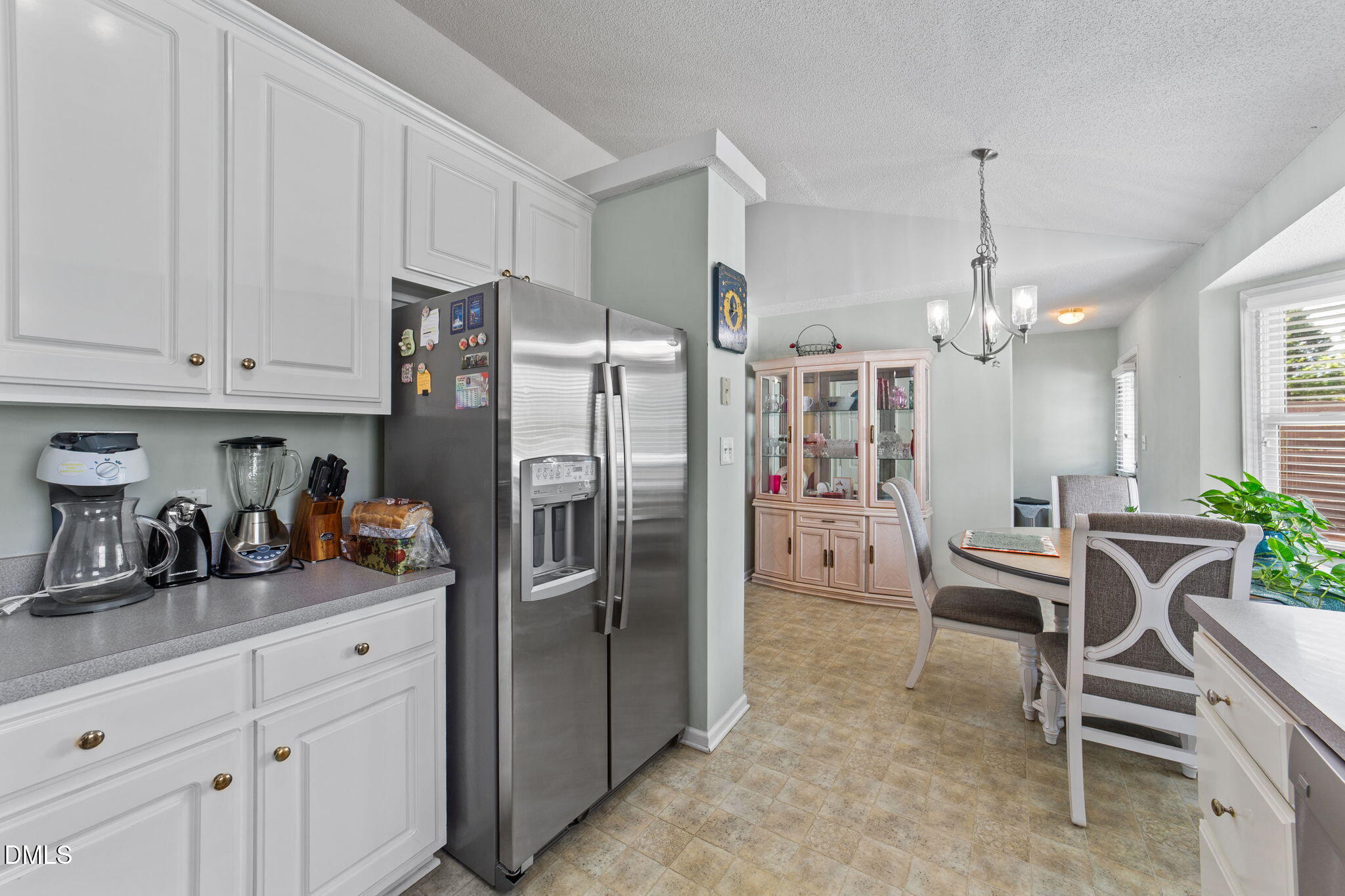 709 Slippery Bank Court Benson, NC 27504 - Photo 28 of 43 a kitchen with refrigerator cabinets and chairs