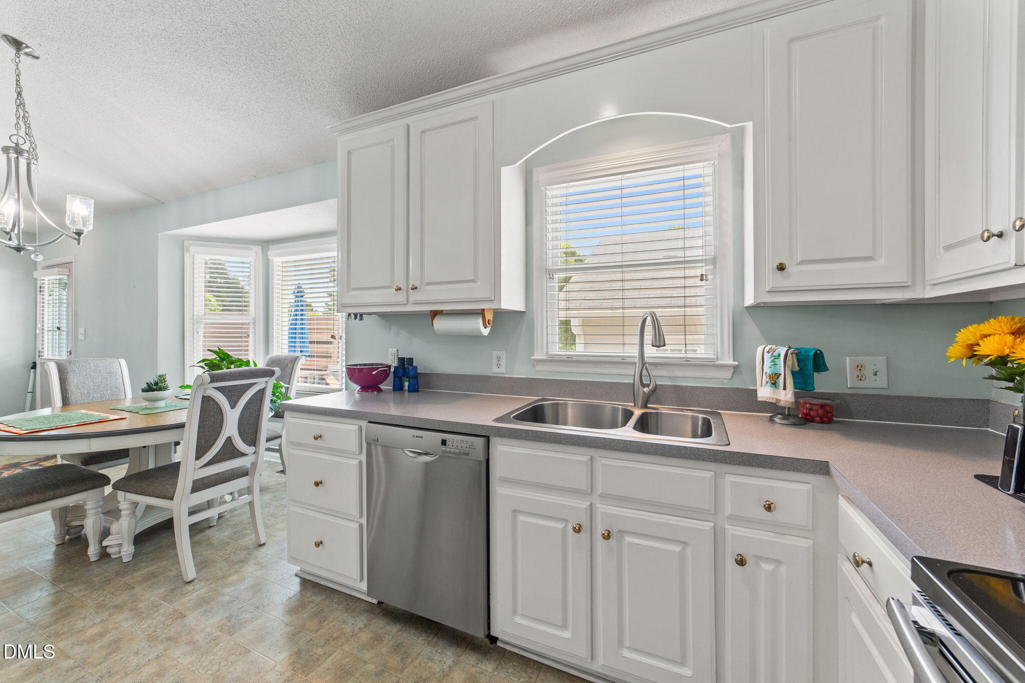 709 Slippery Bank Court Benson, NC 27504 - Photo 29 of 43 a kitchen with white cabinets and sink