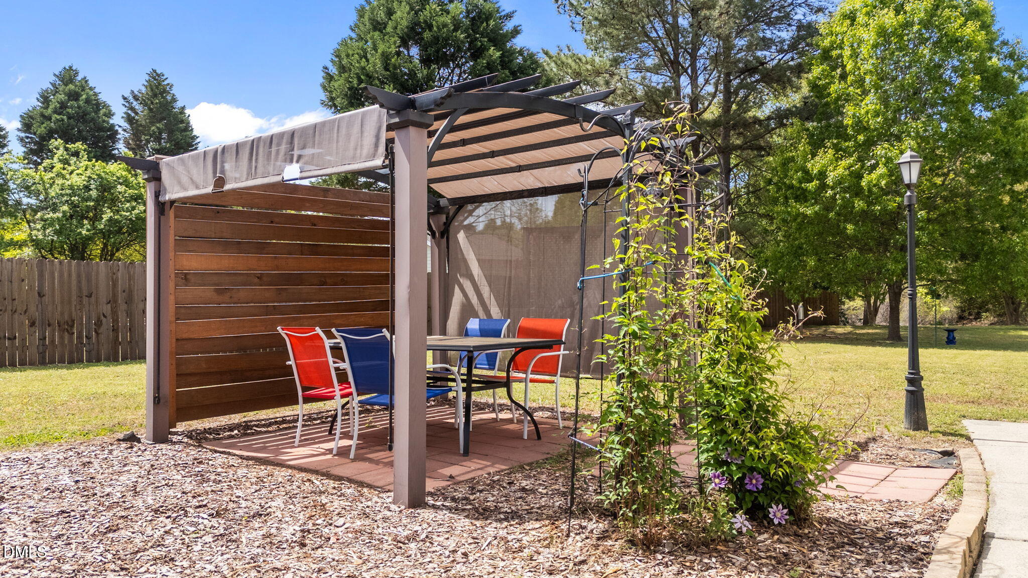 709 Slippery Bank Court Benson, NC 27504 - Photo 7 of 43 a backyard of a house with table and chairs