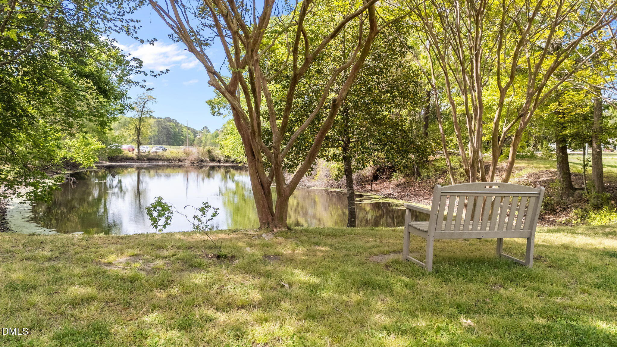 709 Slippery Bank Court Benson, NC 27504 - Photo 10 of 43 a view of backyard with wooden fence and a bench