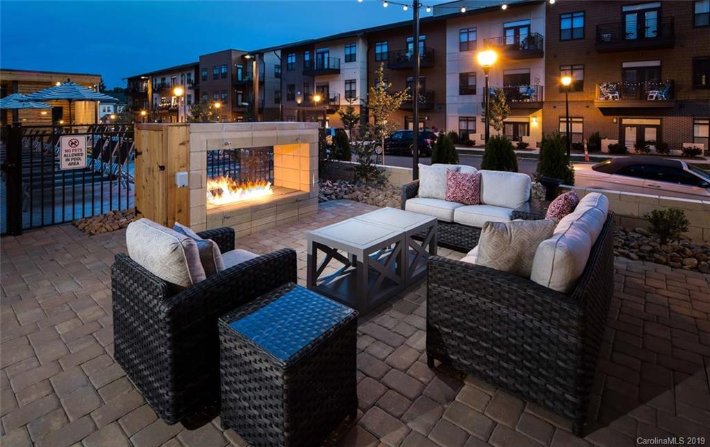 2426 McClintock Road, Unit 405 Charlotte, NC 28205 - Photo 14 of 21 a outdoor living space with patio furniture and a fireplace