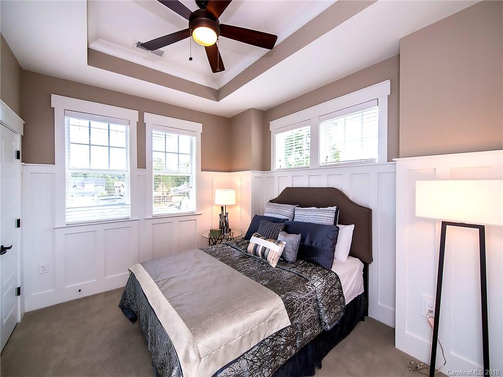 2426 McClintock Road, Unit 405 Charlotte, NC 28205 - Photo 8 of 21 a bed sitting in a bedroom next to a window