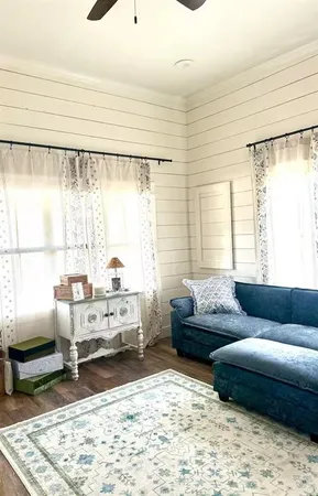 a living room with furniture and a rug