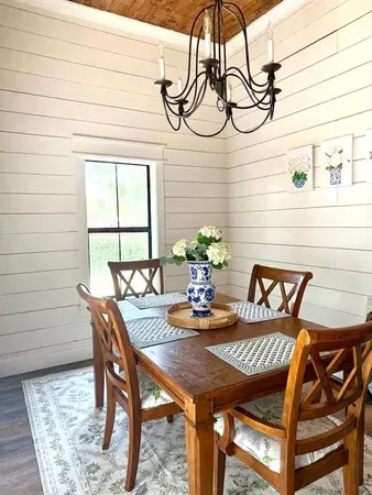 a view of a dining room with furniture and window