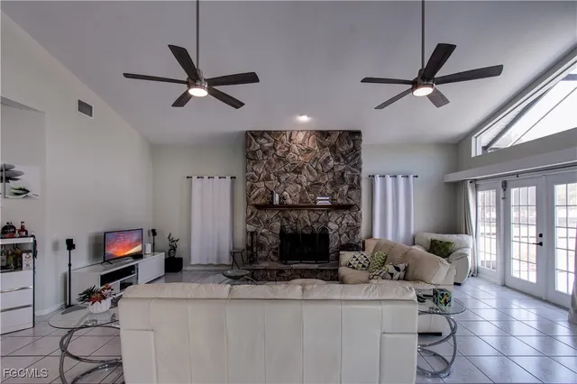 a living room with fireplace furniture and a flat screen tv
