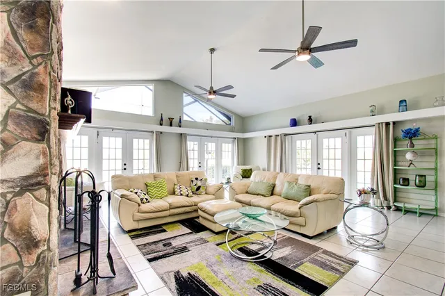 a living room with furniture a flat screen tv and a large window