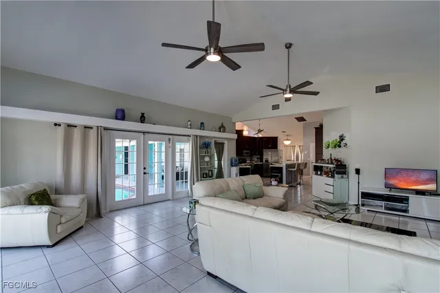 a living room with furniture a flat screen tv and a window