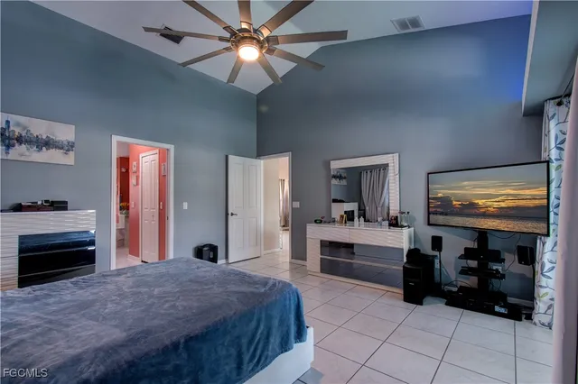 a bedroom with furniture and a flat screen tv