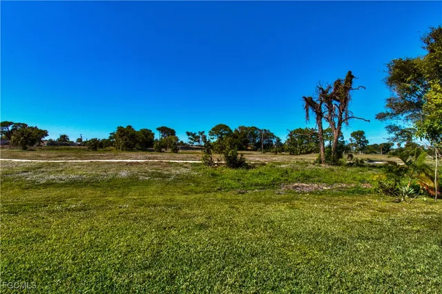a view of a house with swimming pool and sitting area