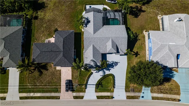 an aerial view of a house with a yard