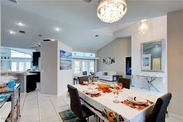 a dining room with furniture and a chandelier