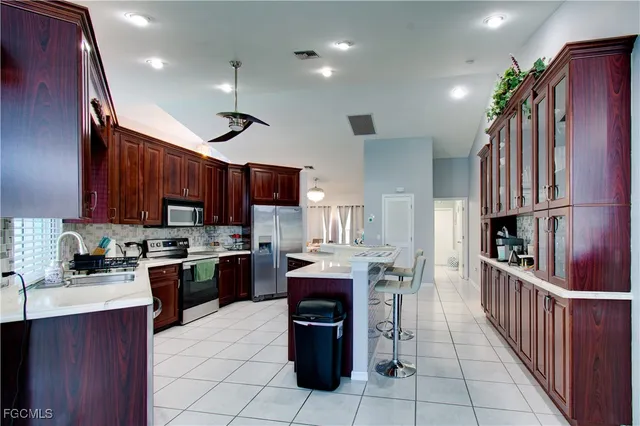 a kitchen with lots of counter top space appliances and cabinets