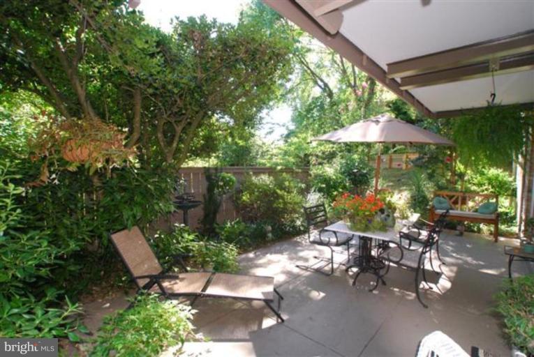101 Cross Keys Road, Unit B Baltimore, MD 21210 - Photo 4 of 12 a backyard of a house with lots of green space and outdoor seating