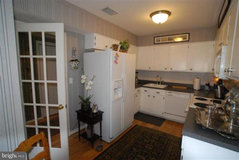 101 Cross Keys Road, Unit B Baltimore, MD 21210 - Photo 6 of 12 a kitchen with granite countertop a refrigerator and a stove top oven