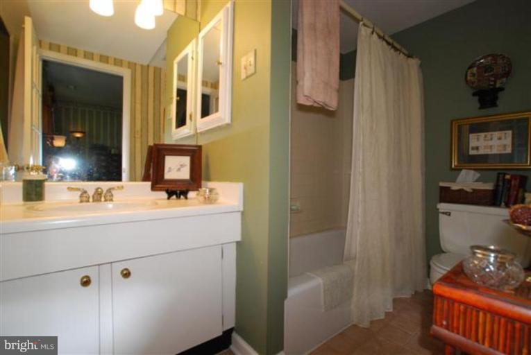 101 Cross Keys Road, Unit B Baltimore, MD 21210 - Photo 10 of 12 a bathroom with a sink and a mirror