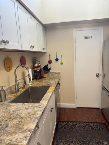 a kitchen with a sink and a refrigerator