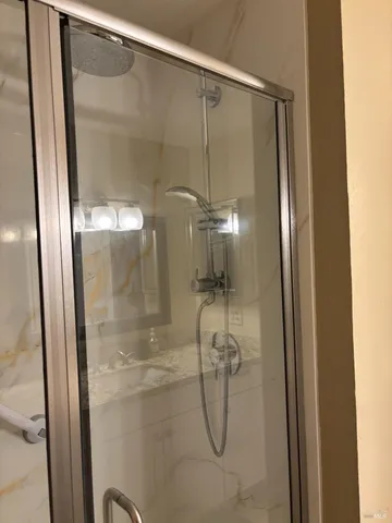 a bathroom with a glass shower door