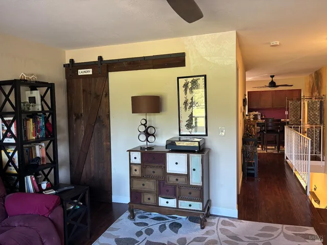 a living room with furniture and a book shelf