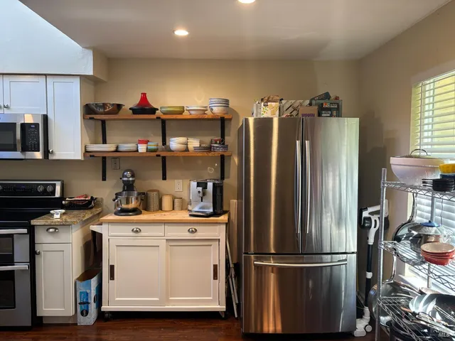 a kitchen with stainless steel appliances a refrigerator sink and cabinets